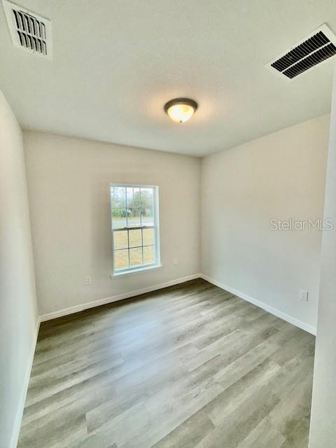 unfurnished room with light hardwood / wood-style flooring