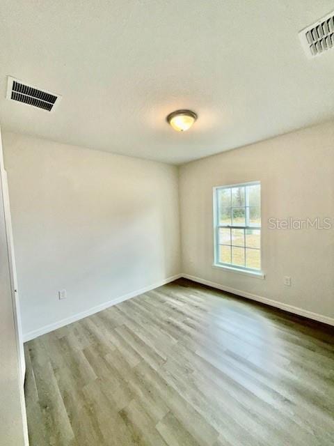 spare room featuring light wood-type flooring