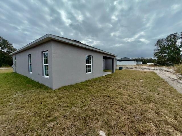 view of side of home featuring a yard