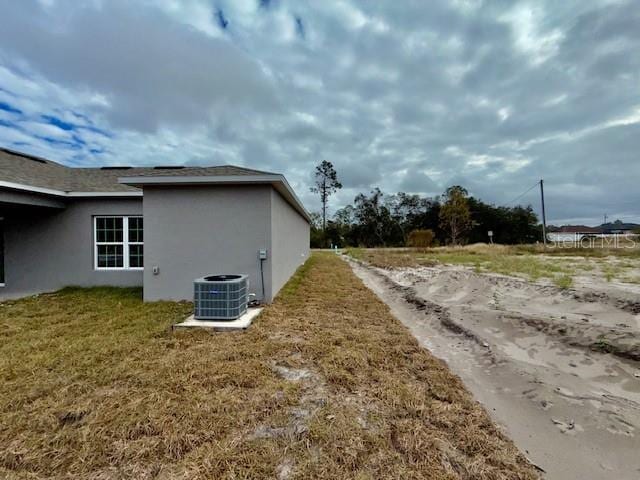 view of side of home featuring central AC