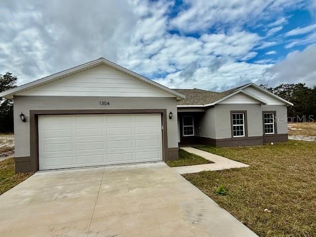 ranch-style house with a garage and a front lawn