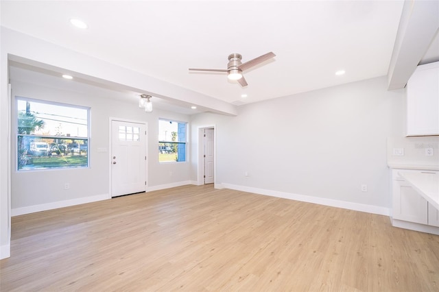 unfurnished living room with light hardwood / wood-style floors and ceiling fan