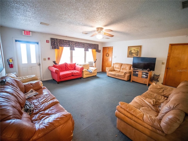 carpeted living room featuring ceiling fan, plenty of natural light, and a textured ceiling