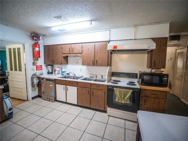 kitchen with a textured ceiling, electric stove, sink, and light tile patterned floors