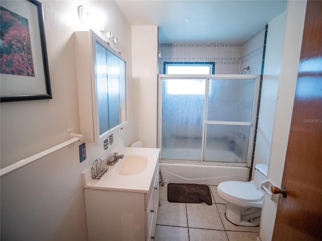 full bathroom with tile patterned floors, vanity, toilet, and enclosed tub / shower combo