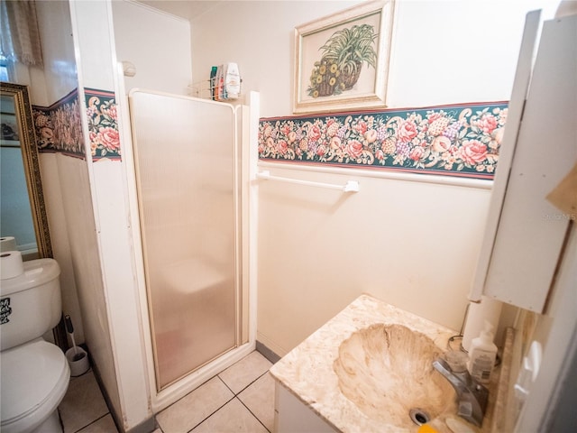 bathroom with tile patterned floors, vanity, toilet, and walk in shower