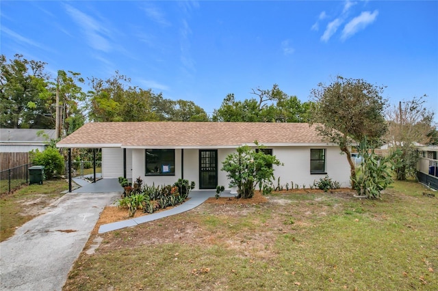 ranch-style home featuring a carport and a front yard