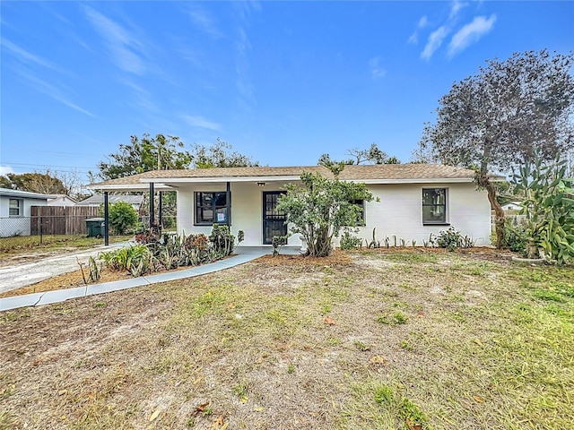 single story home with a porch and a front lawn