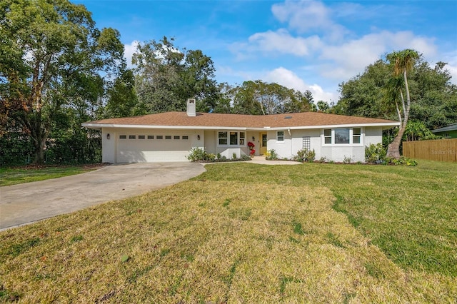 ranch-style house featuring a front yard and a garage