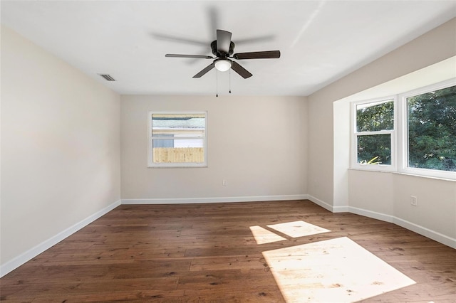 unfurnished room with dark hardwood / wood-style flooring and ceiling fan