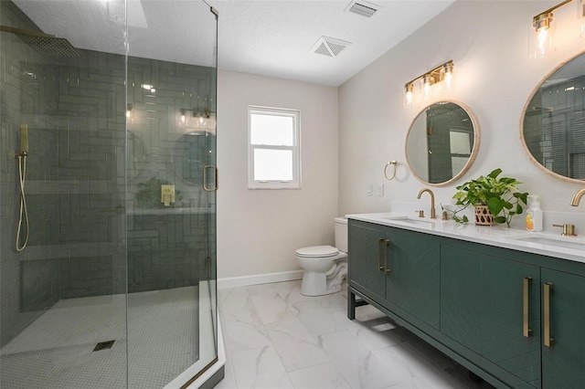 bathroom featuring an enclosed shower, vanity, and toilet