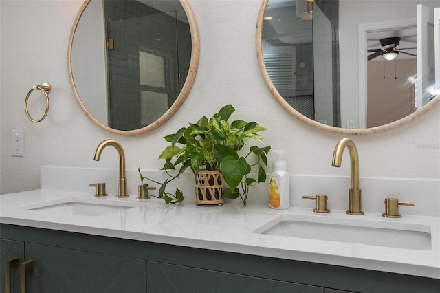 bathroom featuring ceiling fan, a shower with door, and vanity