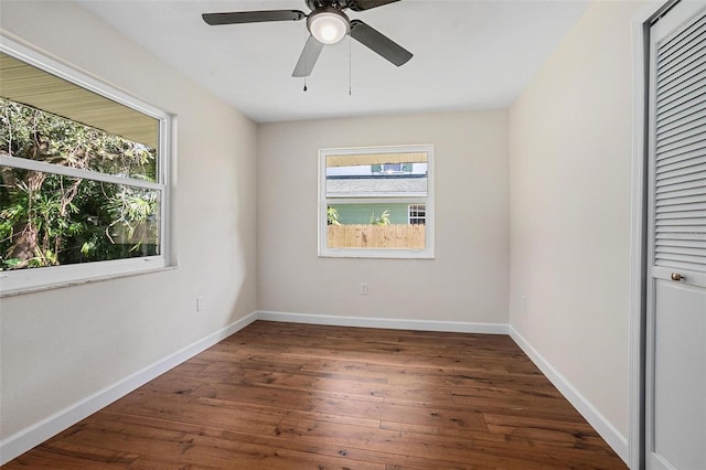 unfurnished room with dark hardwood / wood-style floors and ceiling fan