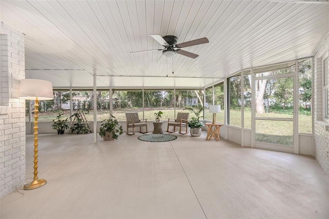 unfurnished sunroom with ceiling fan