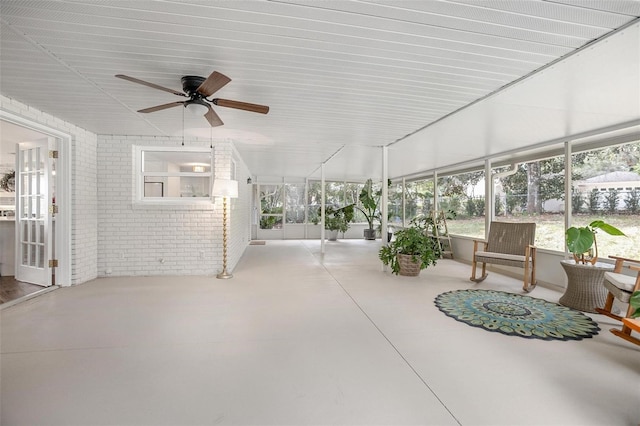 sunroom featuring ceiling fan and a healthy amount of sunlight