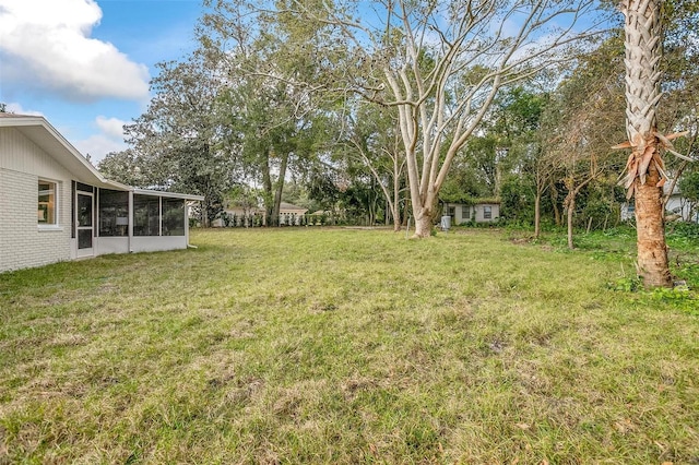 view of yard featuring a sunroom