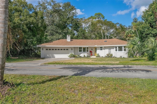 ranch-style home with a front yard and a garage