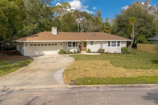 ranch-style house with a garage and a front lawn