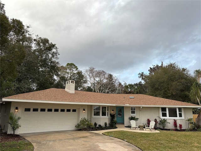 ranch-style home with a garage and a front lawn