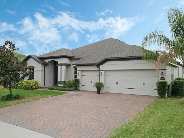 view of front facade with a front yard and a garage