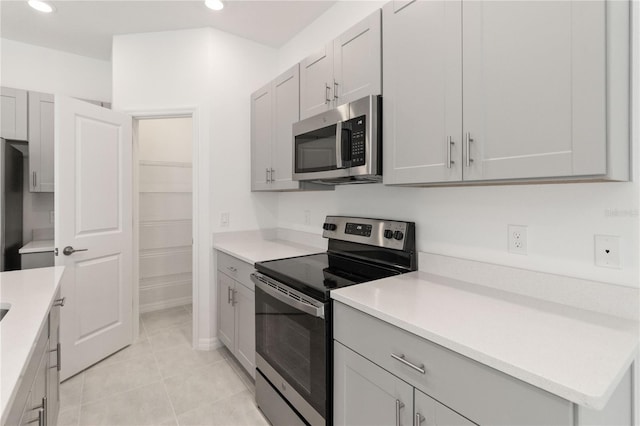 kitchen with appliances with stainless steel finishes and light tile patterned floors