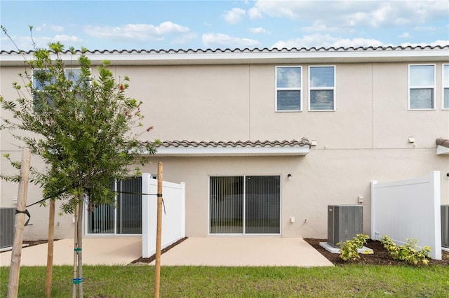 rear view of property featuring a patio area and central air condition unit