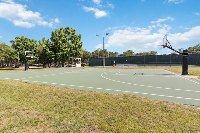 view of sport court with a yard