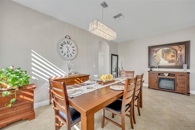 dining room featuring light tile patterned floors and a chandelier