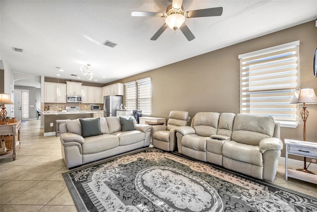 tiled living room featuring ceiling fan