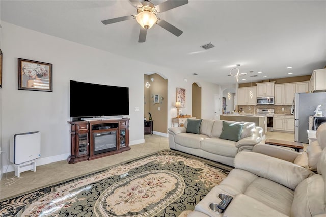 living room featuring ceiling fan and light tile patterned flooring