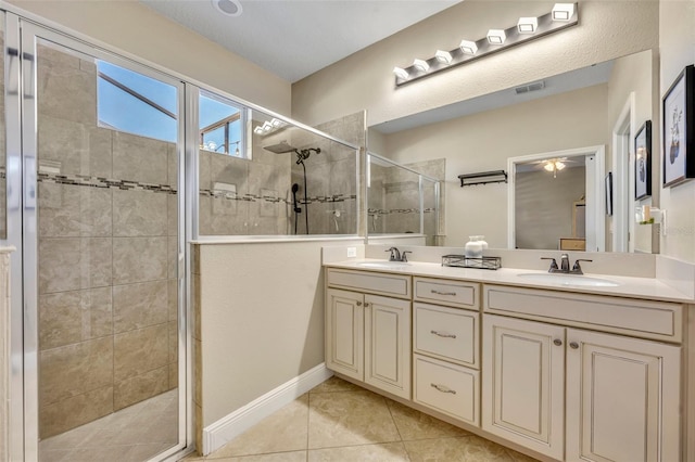 bathroom featuring tile patterned floors, vanity, and tiled shower