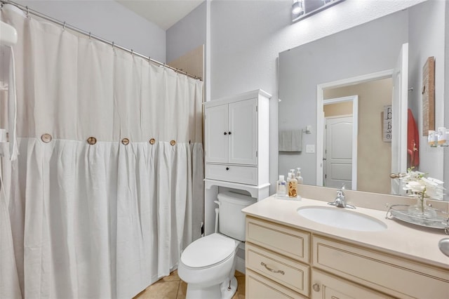 bathroom featuring tile patterned flooring, vanity, and toilet