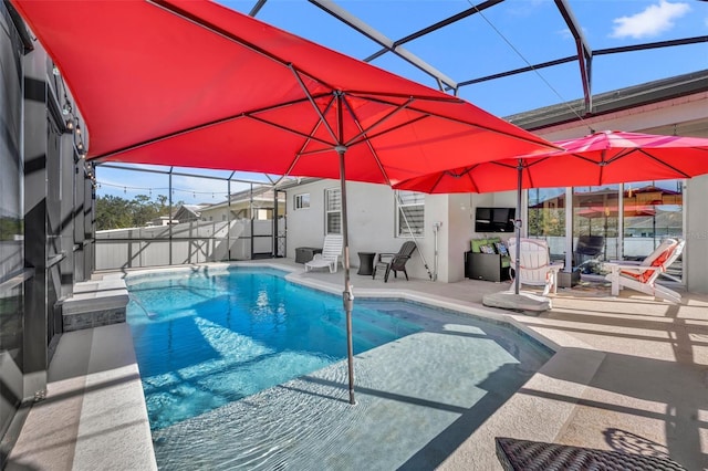 view of pool with a lanai and a patio