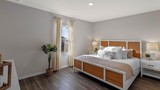 bedroom with dark wood-type flooring