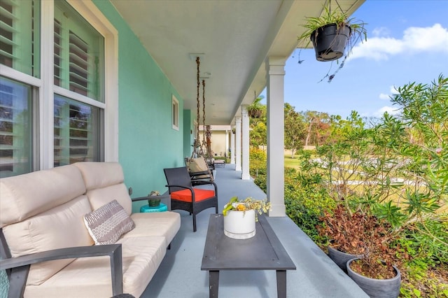 view of patio featuring outdoor lounge area and a porch