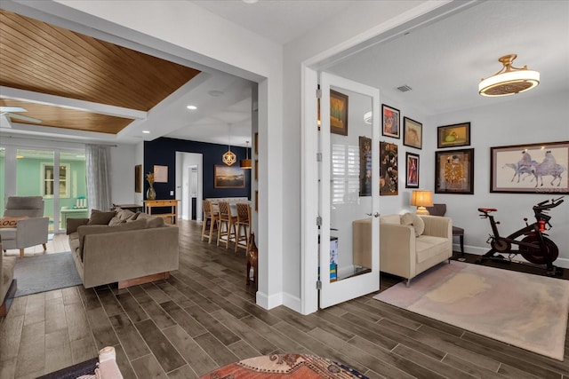 interior space featuring ceiling fan and wood ceiling