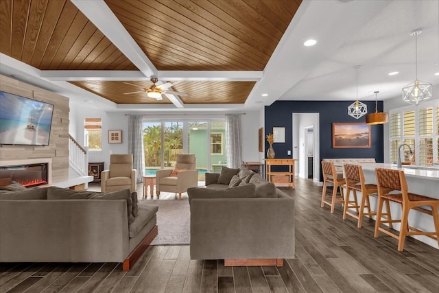 living room featuring ceiling fan, sink, wooden ceiling, beamed ceiling, and dark hardwood / wood-style floors