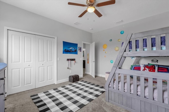 carpeted bedroom featuring a closet and ceiling fan