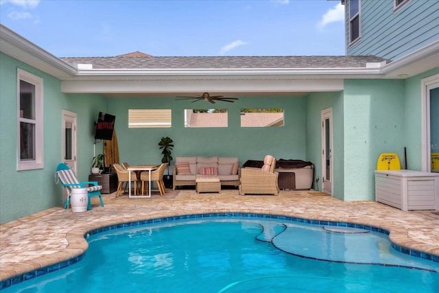 view of swimming pool featuring an outdoor living space, ceiling fan, and a patio