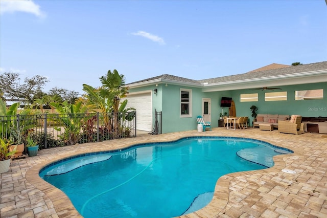 view of swimming pool with an outdoor living space, ceiling fan, and a patio