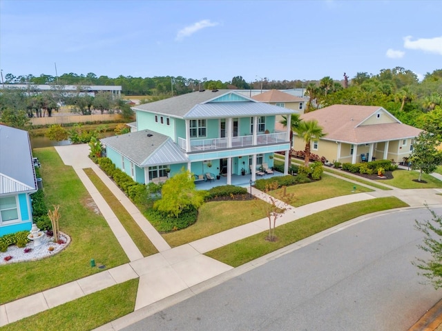 view of front of house with a balcony and a front lawn