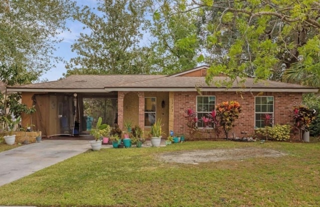 single story home featuring a front yard and a carport