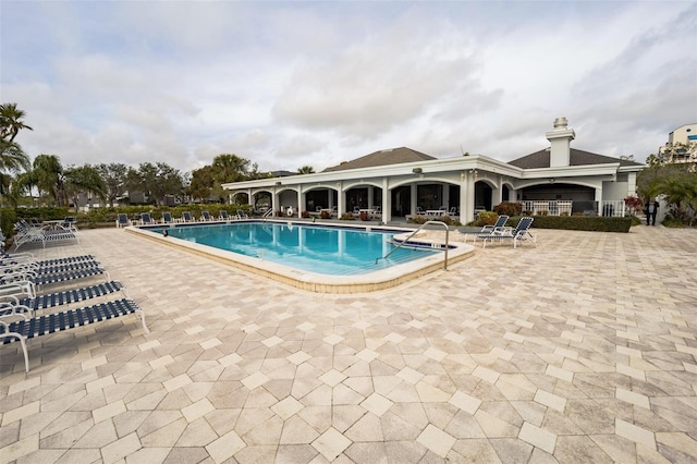 view of swimming pool featuring a patio area