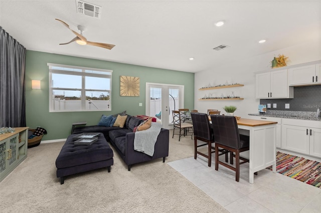 tiled living room featuring ceiling fan