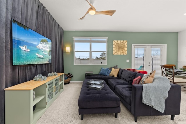 living room with ceiling fan, light carpet, and french doors