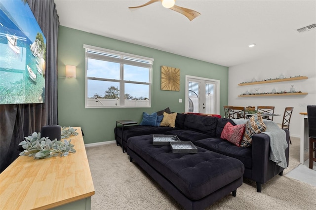 living room featuring ceiling fan and light colored carpet