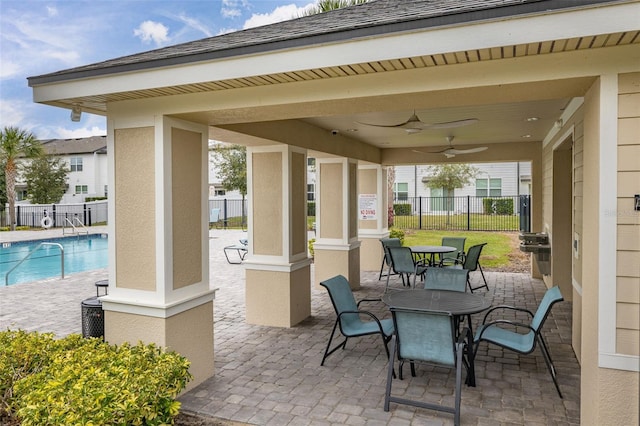 view of patio featuring ceiling fan, a community pool, and a grill