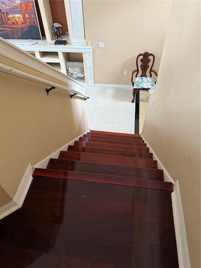 stairs featuring tile patterned flooring