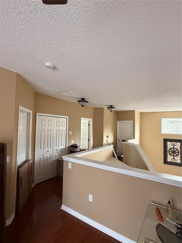 kitchen with dark wood-type flooring and a textured ceiling