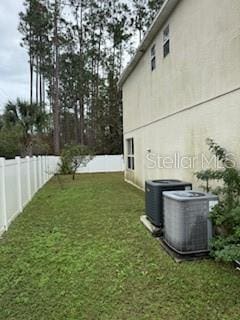 view of yard with central air condition unit